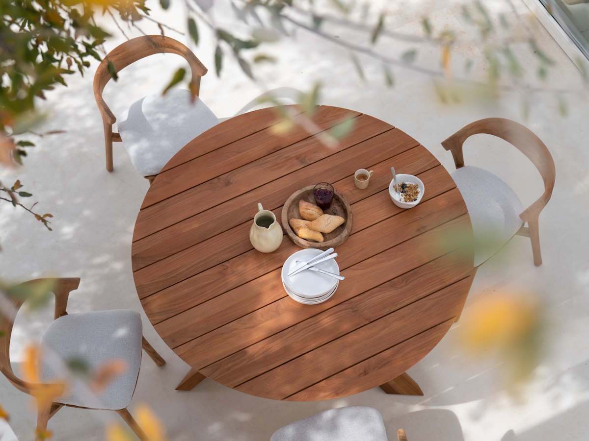 Ethnicraft Teak Bok circular outdoor table with four teak bok chairs