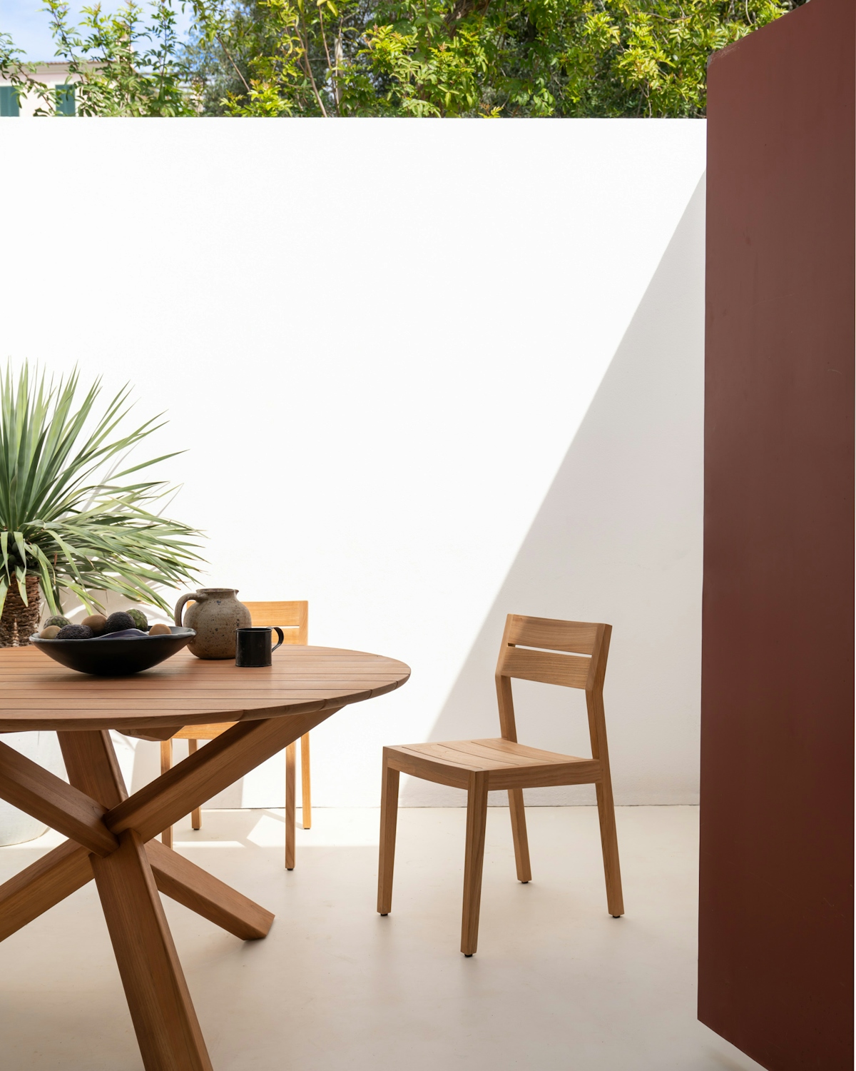 Ethnicraft Bok oak circular outdoor dining table with Teak EX1 outdoor dining chair