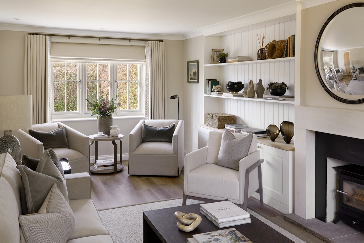Modern country style linen Keswick Swivel Armchair by LuxDeco and Dakota side table by Loom, fresh flowers in rustic vase and large window